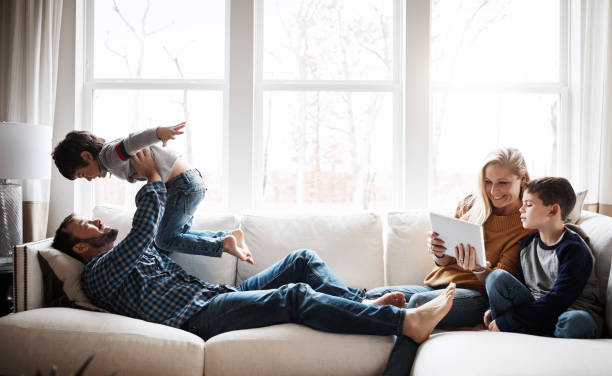 Shot of a happy family spending quality time together on the sofa at home